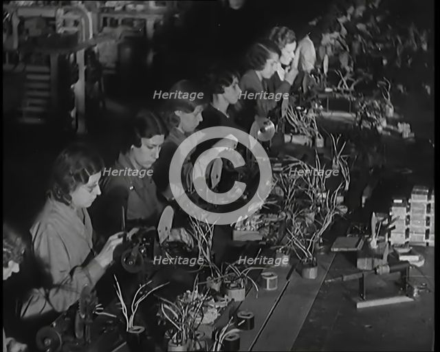 Female Civilians Working on a Factory Production Line, 1931. Creator: British Pathe Ltd.