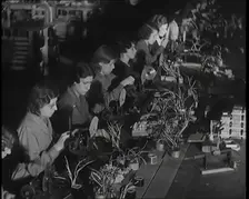 Female Civilians Working on a Factory Production Line, 1931. Creator: British Pathe Ltd