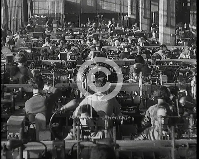 Female Civilians Working on a Factory Production Line, 1931. Creator: British Pathe Ltd.
