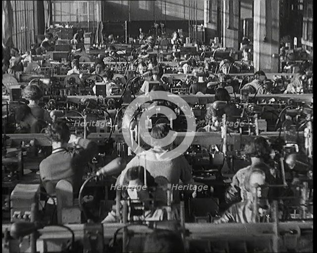 Female Civilians Working on a Factory Production Line, 1931. Creator: British Pathe Ltd.