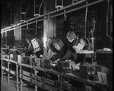 Female Civilians Working on a Factory Production Line, 1931. Creator: British Pathe Ltd