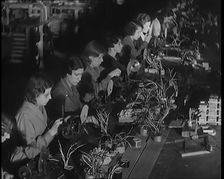Female Civilians Working on a Factory Production Line, 1931. Creator: British Pathe Ltd
