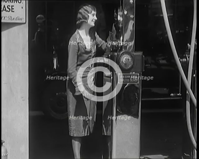 Female Civilians Working Petrol Pumps in a Garage, 1931. Creator: British Pathe Ltd.