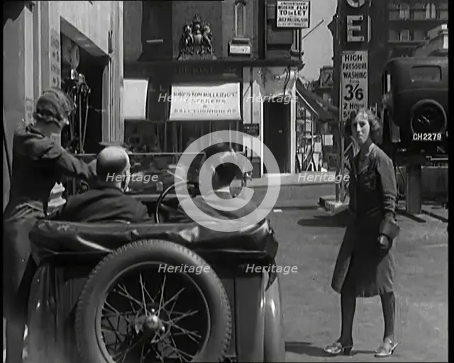 Female Civilians Working Petrol Pumps in a Garage and Filling up a Car, 1931. Creator: British Pathe Ltd.