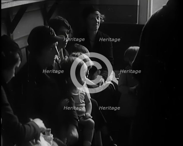 Female Civilians and Their Babies at Health Clinics Where the Babies Are Checked by Female..., 1931. Creator: British Pathe Ltd.