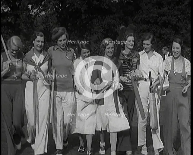 Female Civilians Carrying Cricket Bats Walking in a Line, 1920s. Creator: British Pathe Ltd.