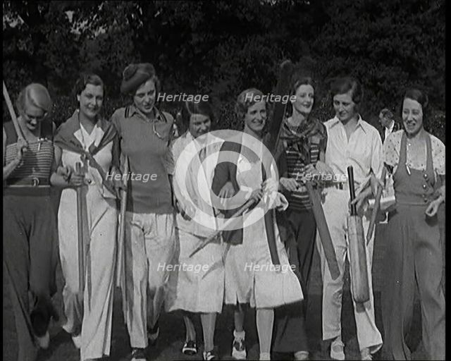 Female Civilians Carrying Cricket Bats Walking in a Line, 1920s. Creator: British Pathe Ltd.
