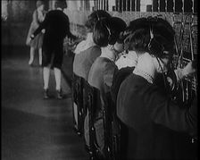 Female Civilians on Roller Skates Working in a Telephone Exchange, 1929. Creator: British Pathe Ltd