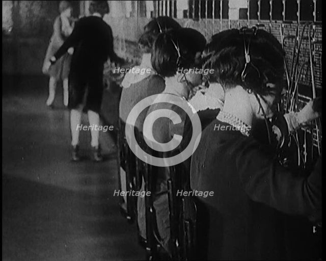Female Civilians on Roller Skates Working in a Telephone Exchange, 1929. Creator: British Pathe Ltd.