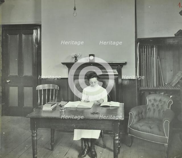 Female student sitting at desk, Shoreditch Technical Institute, London, 1907. Artist: Unknown.