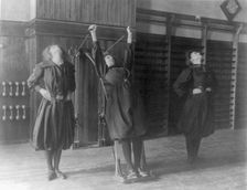 Female students exercising, one with a wall-mounted device using ropes..., Washington, D.C., (1899?) Creator: Frances Benjamin Johnston