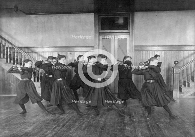 Female students exercising with dumbbells, Western High School, Washington, D.C., (1899?). Creator: Frances Benjamin Johnston.