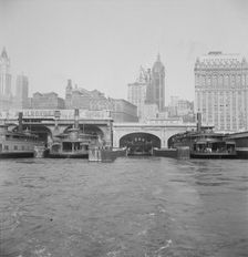 Ferry boats still make train connections which transports passengers in...of New York City, 1939. Creator: Dorothea Lange