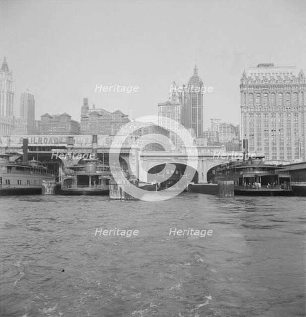 Ferry boats still make train connections which transports passengers in...of New York City, 1939. Creator: Dorothea Lange.