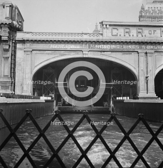 Ferry slip seen from ferry which transports passengers across the Hudson..., New York City, 1939. Creator: Dorothea Lange.