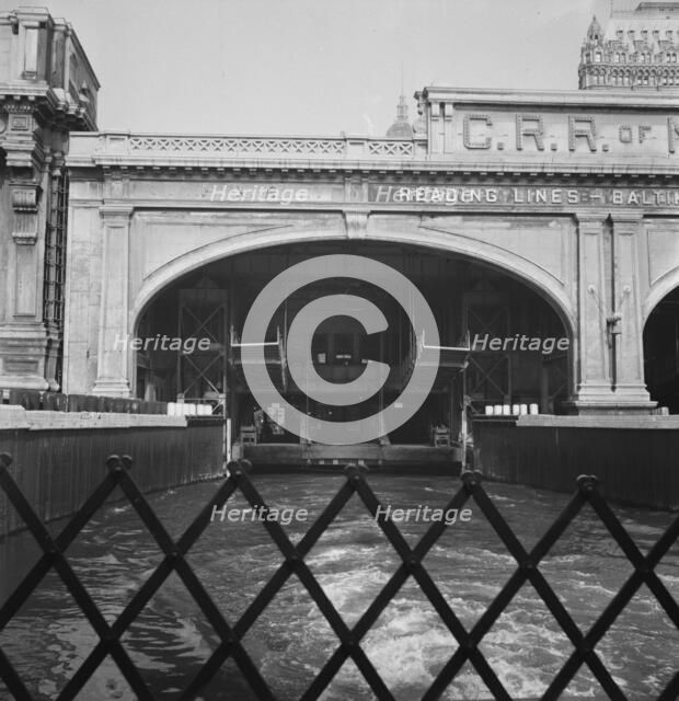 Ferry slip seen from ferry which transports passengers across the Hudson..., New York City, 1939. Creator: Dorothea Lange.