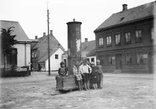 Five boys and one little girl by the old city pump, Landskrona, Sweden, 1905. Creator: Unknown