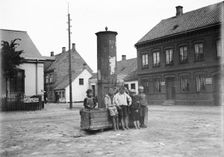 Five boys and one little girl by the old city pump, Landskrona, Sweden, 1905. Creator: Unknown