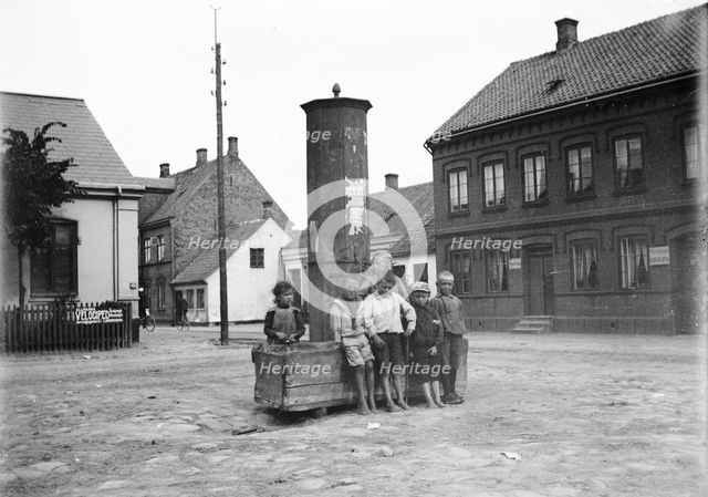 Five boys and one little girl by the old city pump, Landskrona, Sweden, 1905. Creator: Unknown.