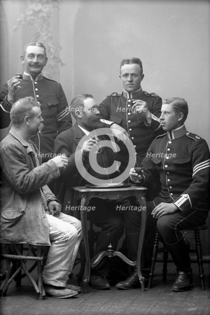 Five men drinking in the photographer's studio, Landskrona, Sweden, 1910.  Creator: Unknown.