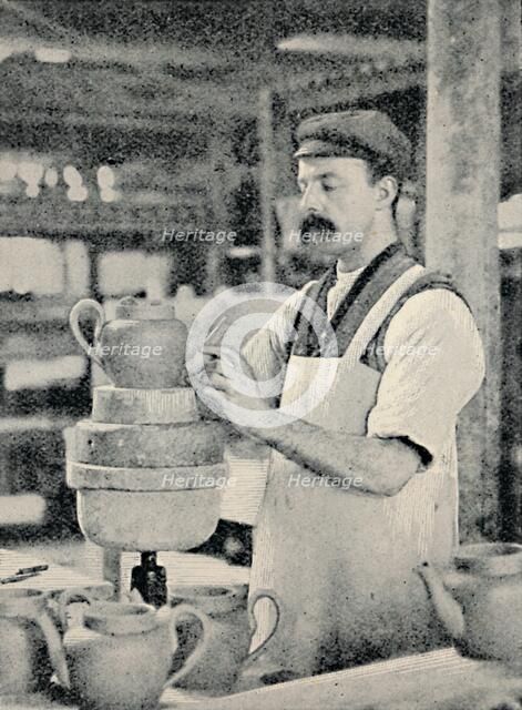 'Fixing Spout on a Teapot', c1917. Artist: Unknown.