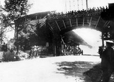 FIAT of Luigi Storero going under a bridge during the 1904 Gordon Bennett Cup, Homburg, Germany. Creator: Unknown