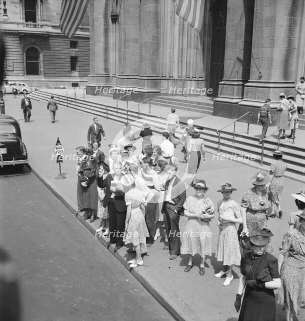 Fifth Avenue at Saint Patrick's Cathedral, waiting for an uptown bus, New York City, 1939. Creator: Dorothea Lange.