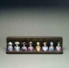 Figurines depicting lady golfers, early 20th century. Creator: Unknown