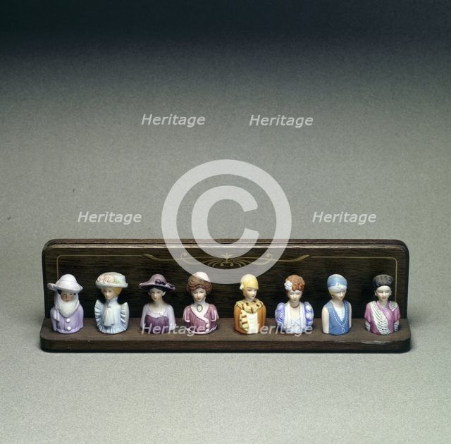 Figurines depicting lady golfers, early 20th century. Creator: Unknown.