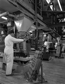 Filling bags of animal feed, Spillers Animal foods, Gainsborough, Lincolnshire, 1963. Creator: Michael Walters
