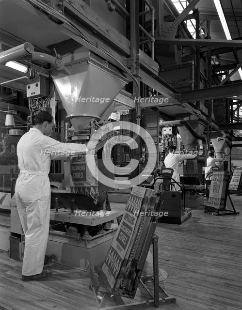 Filling bags of animal feed, Spillers Animal foods, Gainsborough, Lincolnshire, 1963. Creator: Michael Walters.