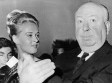 Film director Alfred Hitchcock with the star of The Birds Tippi Hedren, Cannes, France, 1965