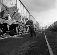 Final adjustments to a rail truck hauling coal from Lynemouth Colliery, Northumberland, 1963. Creator: Michael Walters