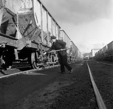 Final adjustments to a rail truck hauling coal from Lynemouth Colliery, Northumberland, 1963. Artist: Michael Walters