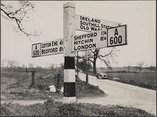 Finger post road sign on the A600 between Bedford and Shefford, Southill, 1940-1960. Creator: George R Long