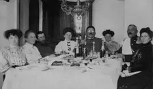 Fire Chief A. F. Domishkevich Sitting at a Table Set for a Holiday Together with..., early 20th cent Creator: Unknown