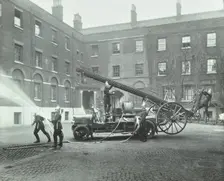 Fireman using a hose, London Fire Brigade Headquarters, London, 1910