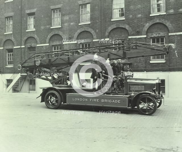 Firemen aboard a fire engine, London Fire Brigade Headquarters, London, 1929. Artist: Unknown.