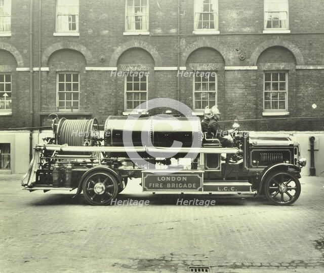 Firemen aboard a foam tender, London Fire Brigade Headquarters, London, 1929. Artist: Unknown.
