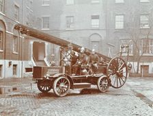 Firemen aboard a motor fire escape vehicle, London Fire Brigade Headquarters, London, 1909