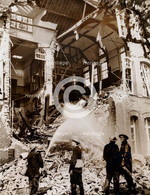 Firemen at work on a children's school, East London, the Blitz, World War II, 13 September 1940. Creator: Unknown.