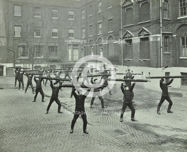Firemen carrying out scaling ladder drill, London Fire Brigade Headquarters, 1910. Artist: Unknown.