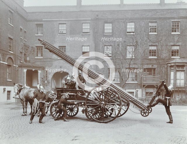 Firemen demonstrating a horse-drawm escape vehicle, London Fire Brigade Headquarters, London, 1910. Artist: Unknown.