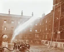 Firemen demonstrating hoses worked by a petrol motor pump, London Fire Brigade Headquarters, 1909