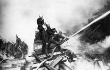 Firemen fighting a fire at a timber yard, London, 1926-1927