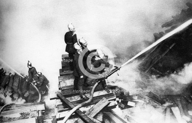 Firemen fighting a fire at a timber yard, London, 1926-1927. Artist: Unknown