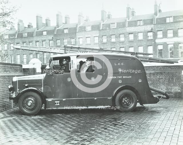 Firemen inside a fire engine, Kingsland Road Fire Station, London, 1935. Artist: Unknown.