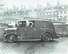 Firemen inside a fire engine, Kingsland Road Fire Station, London, 1935