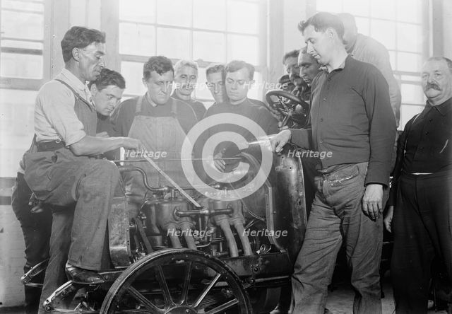 Firemen studying auto motor, between c1910 and c1915. Creator: Bain News Service.