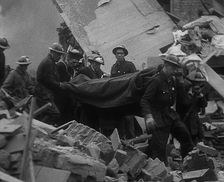 Firefighters Carrying Out a Corpse from a Bombed Out Building, 1940. Creator: British Pathe Ltd